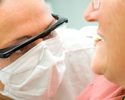 Doctor examining the mouth of an elderly patient